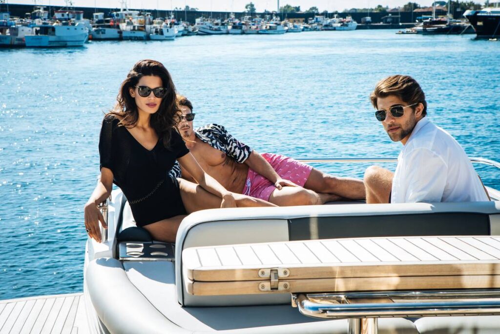 Friends taking a yacht tour in Taormina